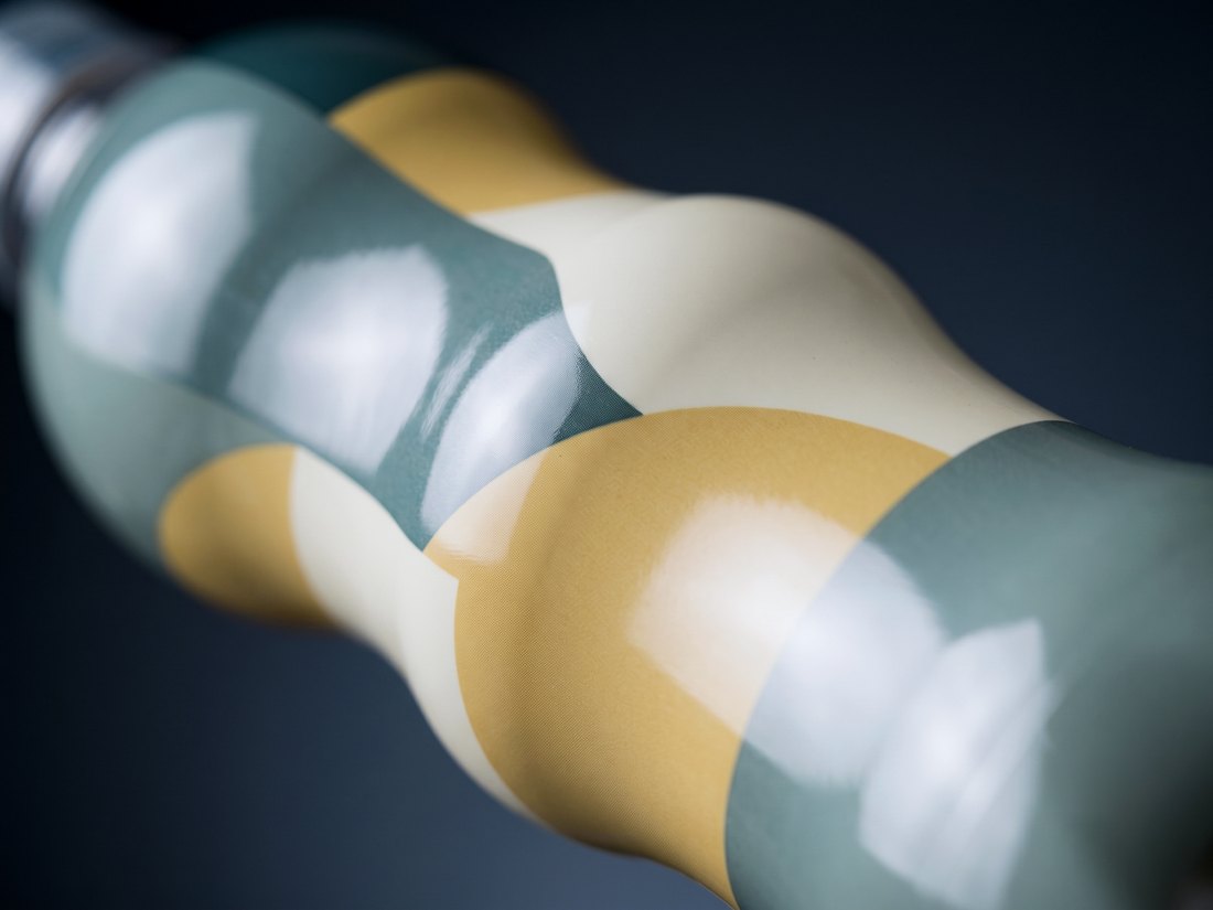 Close-up of a shrink sleeve conforming smoothly to the waist of a contoured bottle